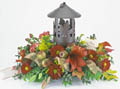 fall arrangement filled with flowers such as fall mums, alstroemeria, and yellow aster.