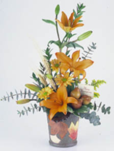 fall arrangement filled with flowers such as fall mums, alstroemeria, and yellow 	aster